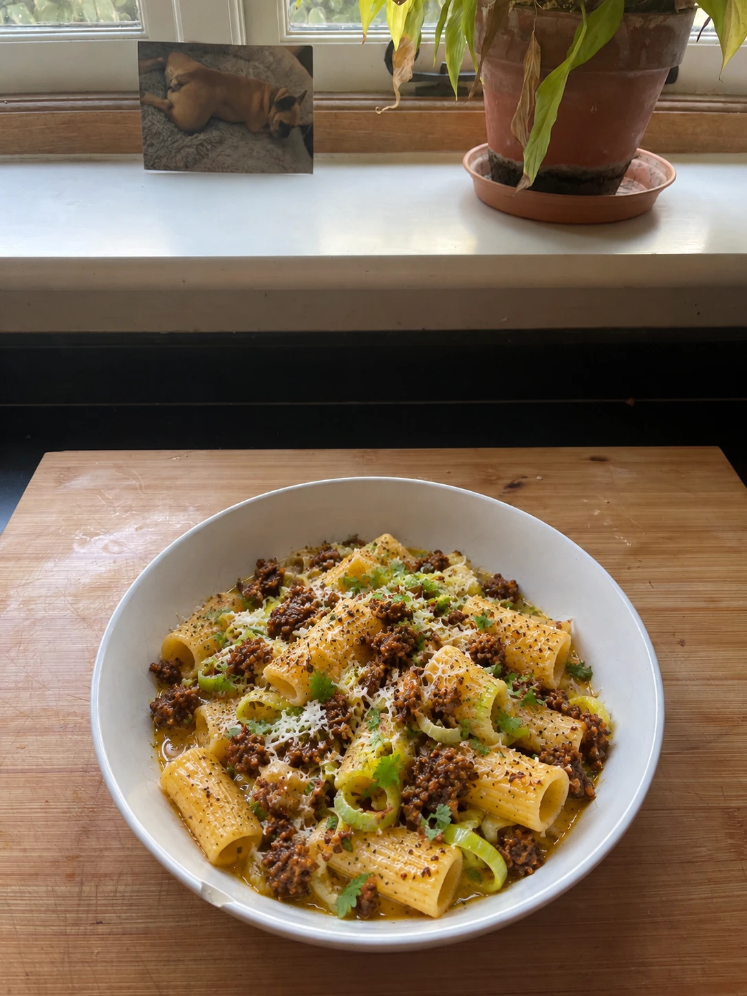 Haggis and leek rigatoni with parsley and Parmesan, on a wooden board by the kitchen window